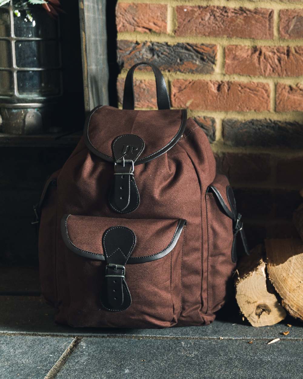 Brown coloured Jack Pyke Canvas Day Pack on wall background 