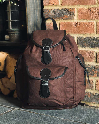 Brown coloured Jack Pyke Canvas Day Pack on wall background 