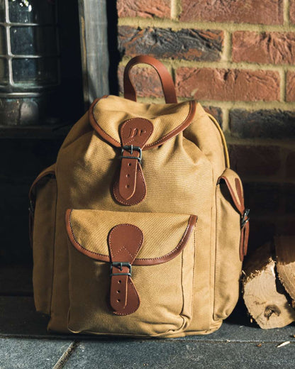 Fawn coloured Jack Pyke Canvas Day Pack on wall background 