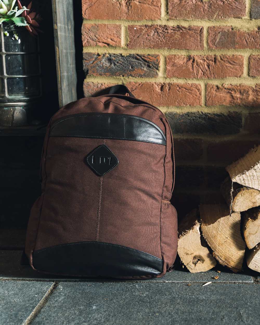 Brown coloured Jack Pyke Canvas Field Pack on brick wall background 