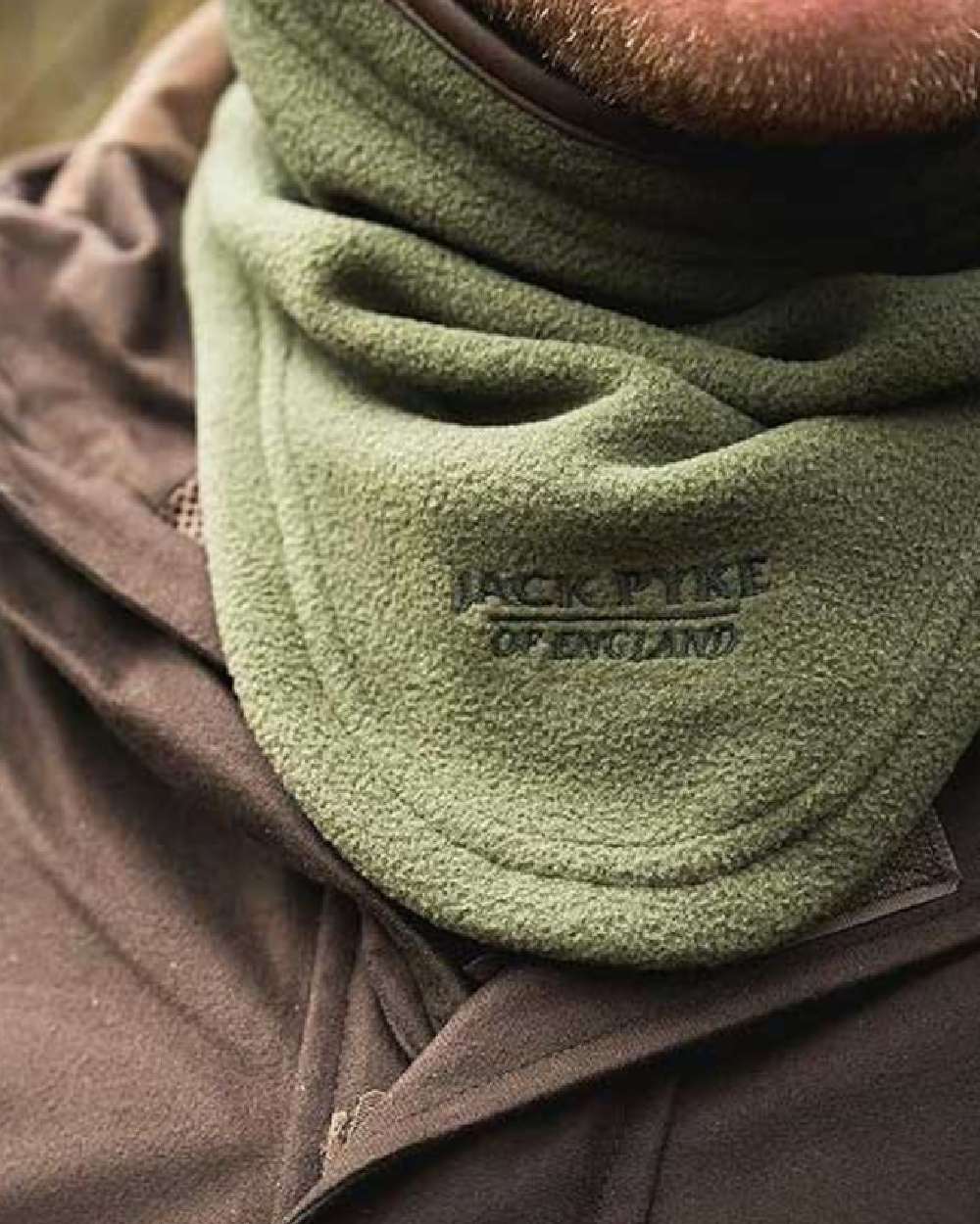 Light Olive coloured Jack Pyke Countryman Fleece Neck Gaiter on blurry background 