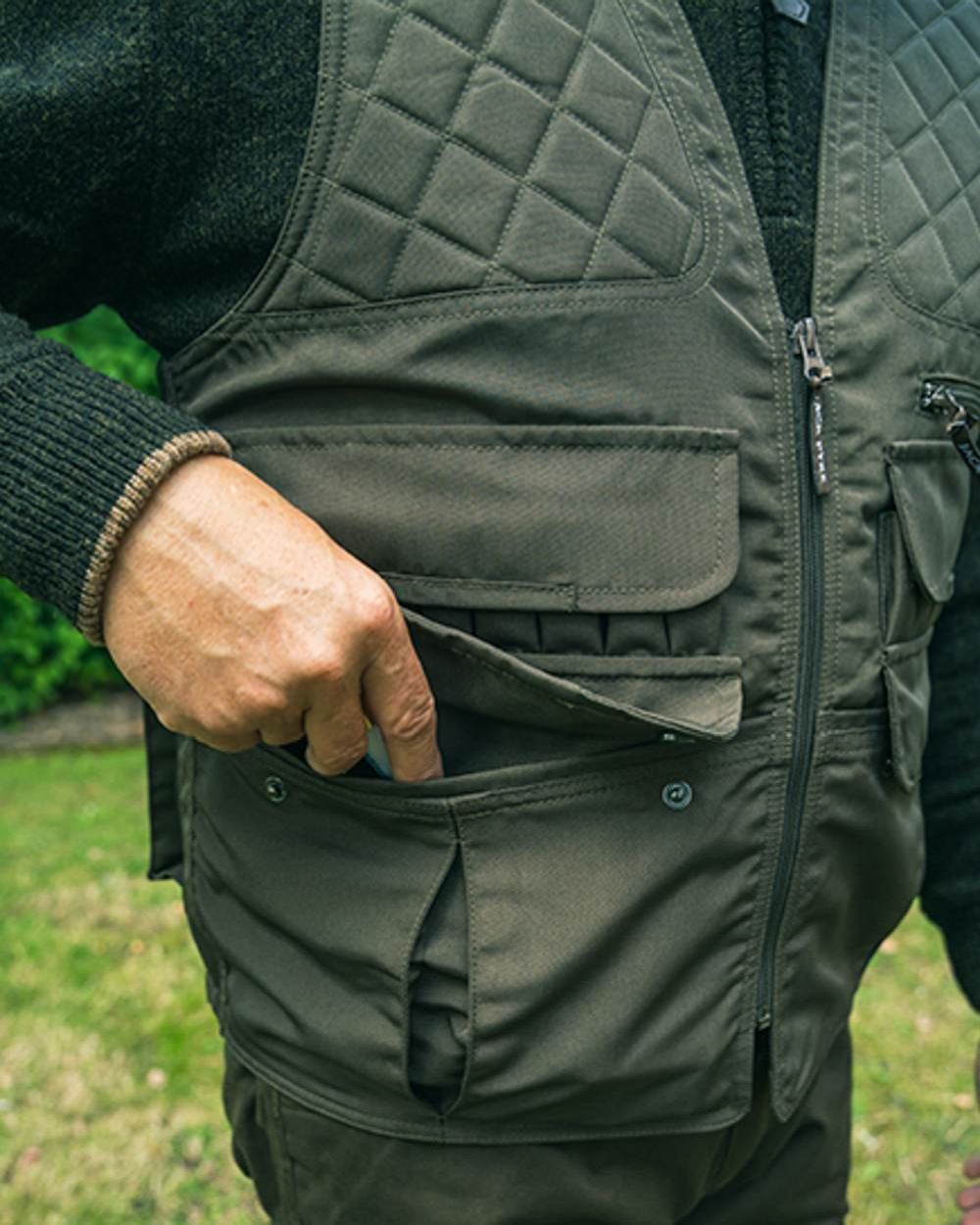 Olive Green coloured Jack Pyke Countryman Vest on grass background 