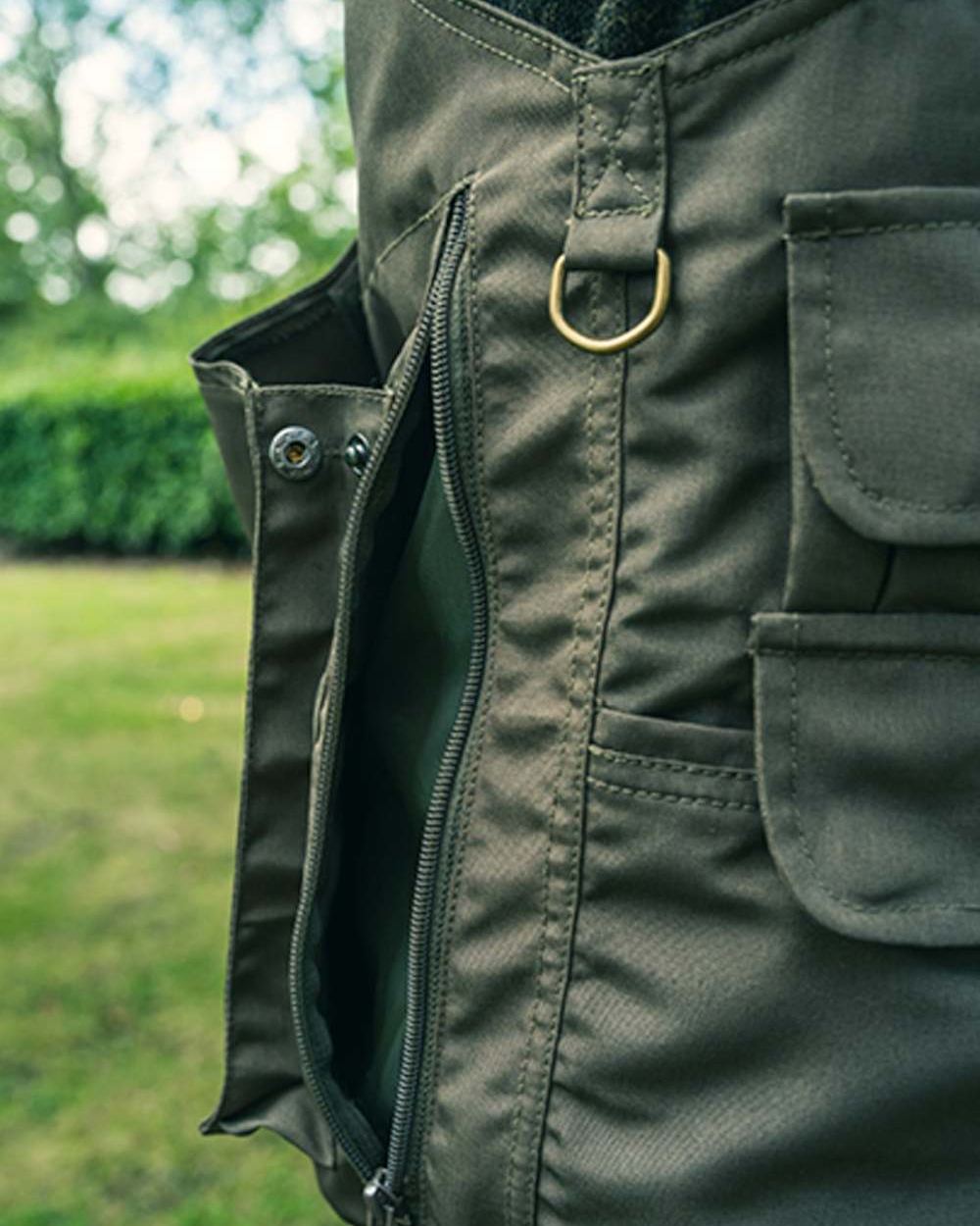 Olive Green coloured Jack Pyke Countryman Vest on grass background 