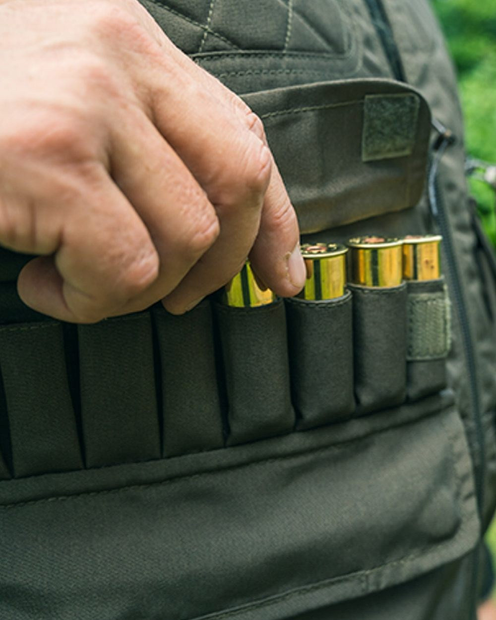 Olive Green coloured Jack Pyke Countryman Vest on grass background 