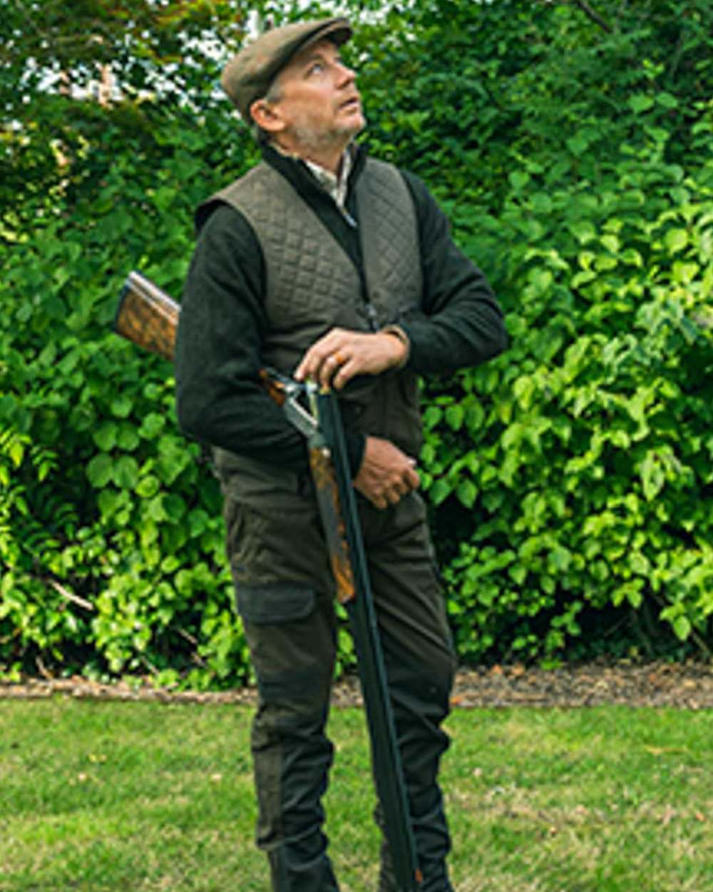 Olive Green coloured Jack Pyke Countryman Vest on grass background 