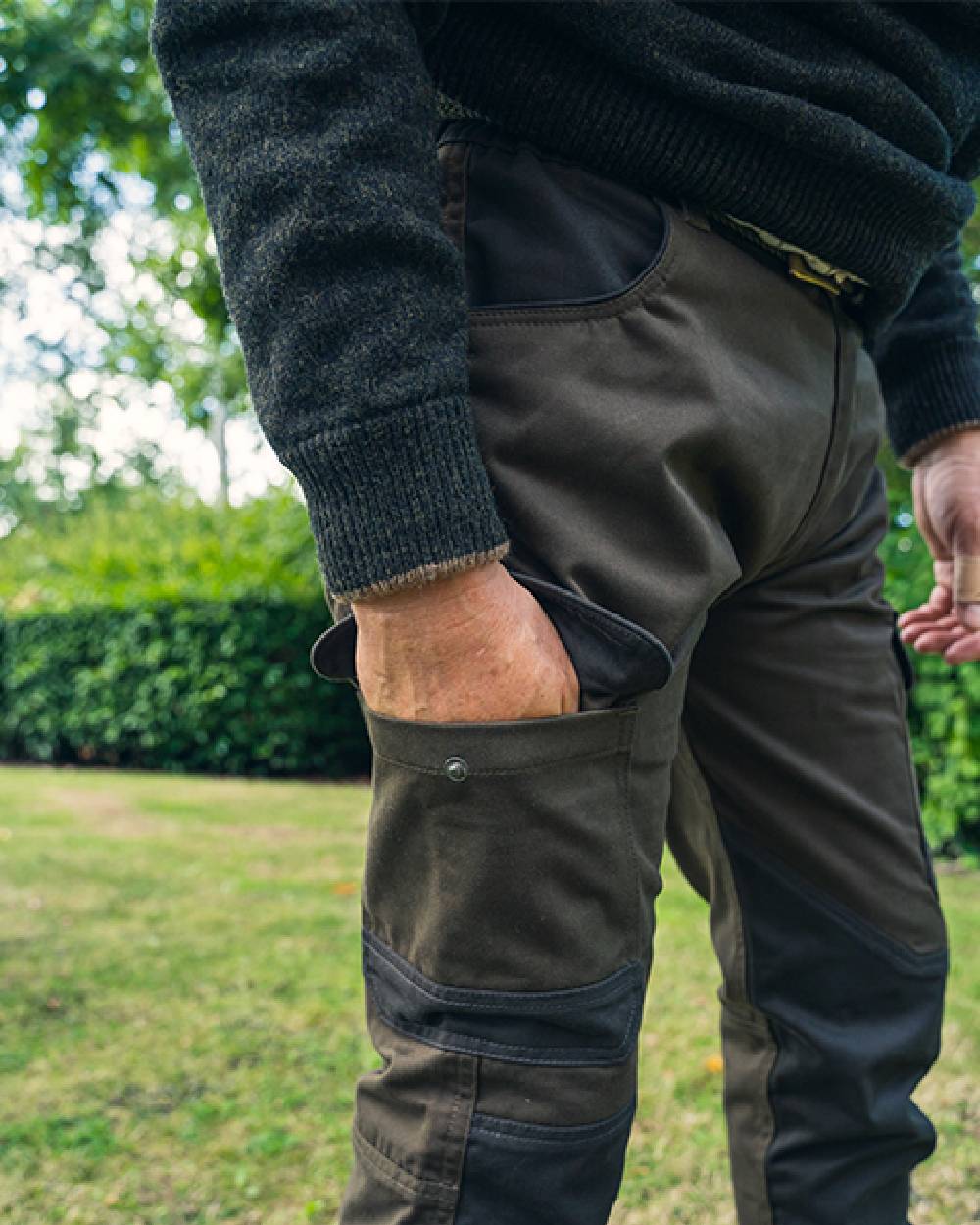 Contrast Green coloured Jack Pyke Fieldman Trousers on grass background 