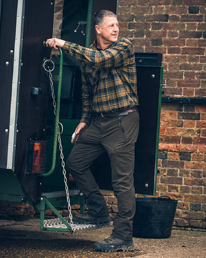 Brown coloured Jack Pyke Flannel Shirt on backyard background 