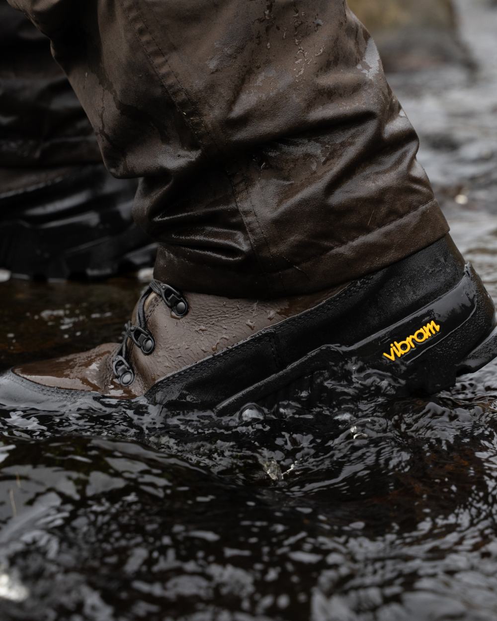 Brown coloured Jack Pyke Hunters Boots on water background 