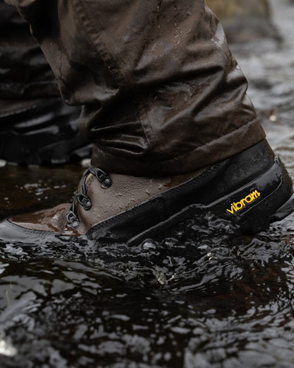 Brown coloured Jack Pyke Hunters Boots on water background 