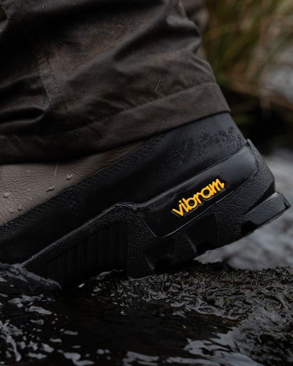 Brown coloured Jack Pyke Hunters Boots on water background 