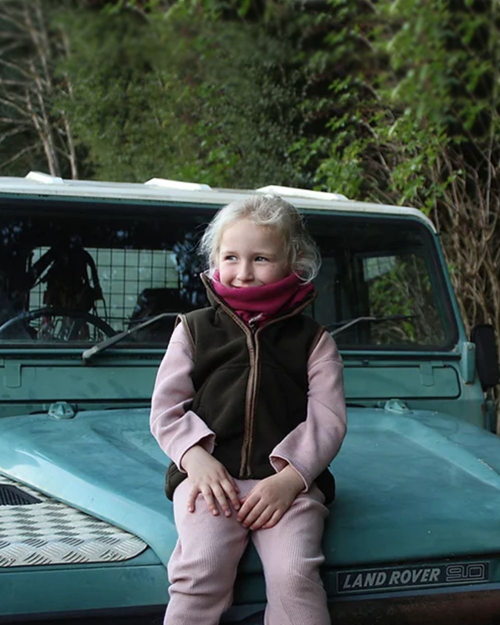 Dark Olive coloured Jack Pyke Junior Countryman Gilet on forest background 