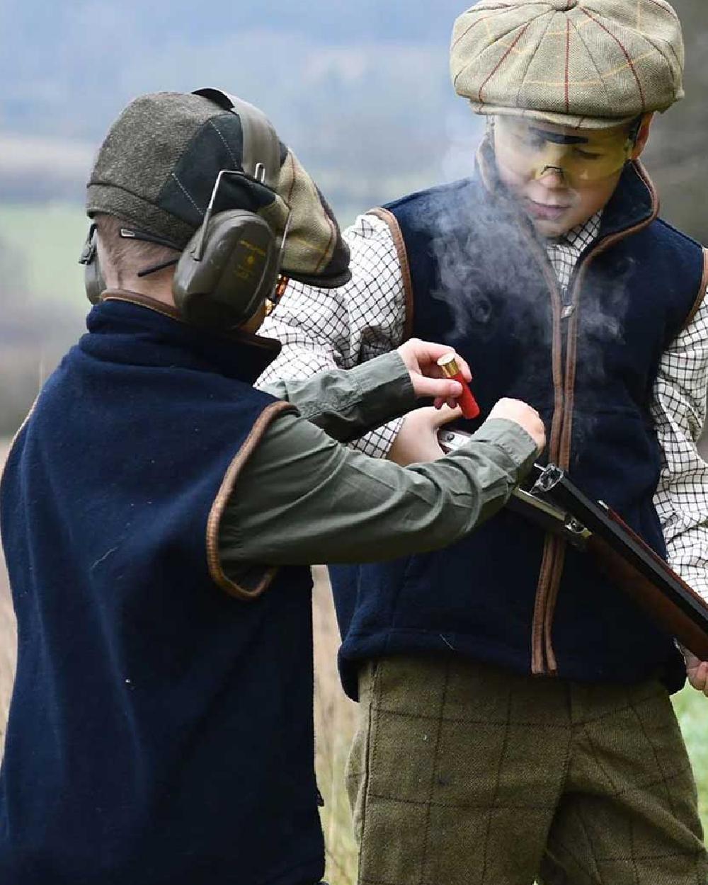 Navy coloured Jack Pyke Junior Countryman Gilet on sky background 