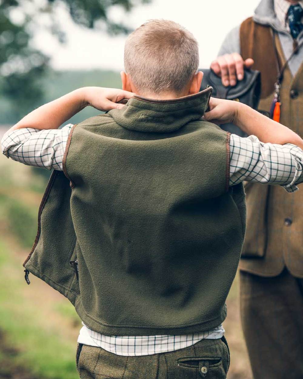 Dark Olive coloured Jack Pyke Junior Countryman Gilet on blurry background 