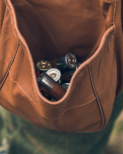 Tan coloured Jack Pyke Leather Cartridge Pouch on blurry background 