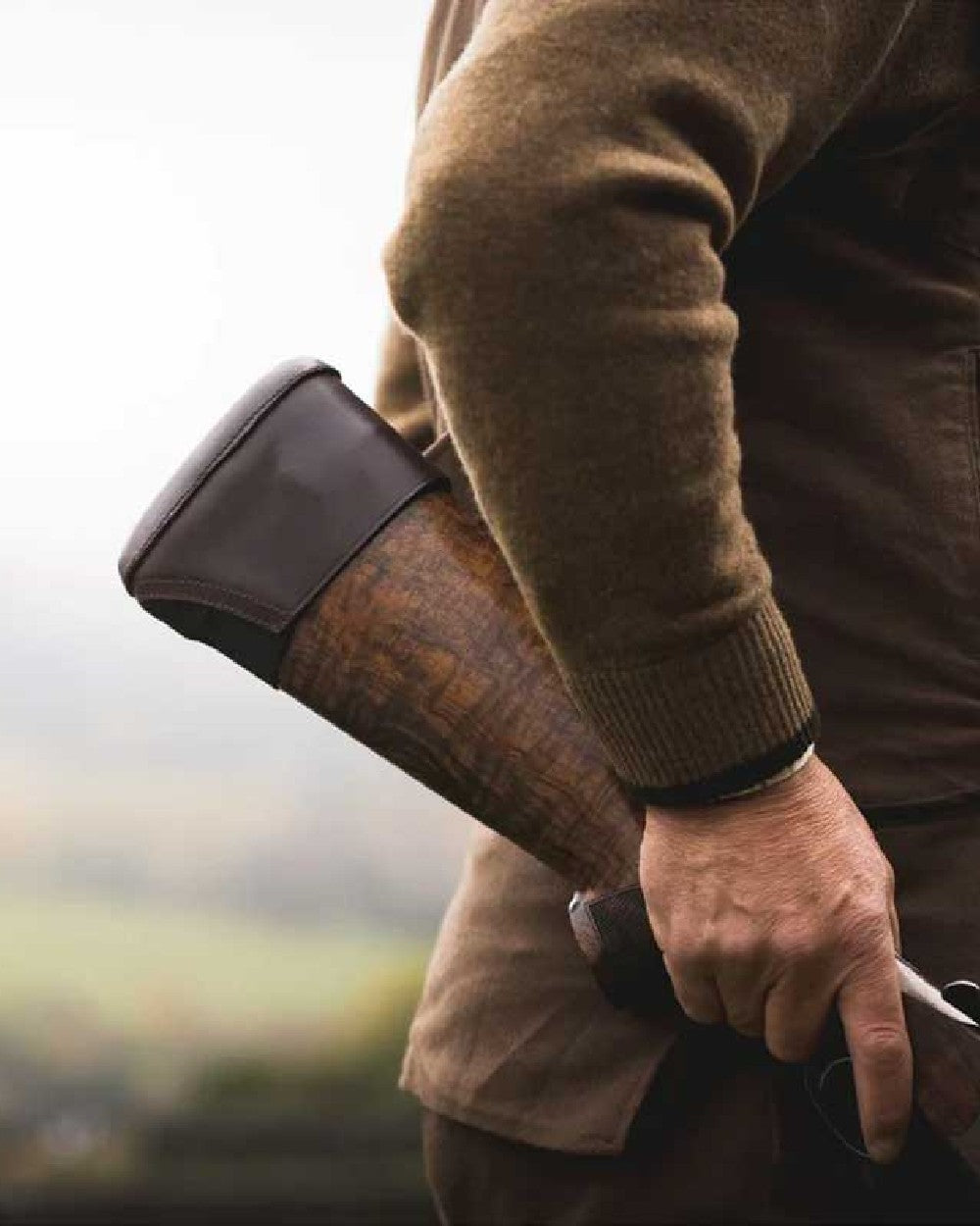 Brown coloured Jack Pyke Leather Stock Pad on blurry background 