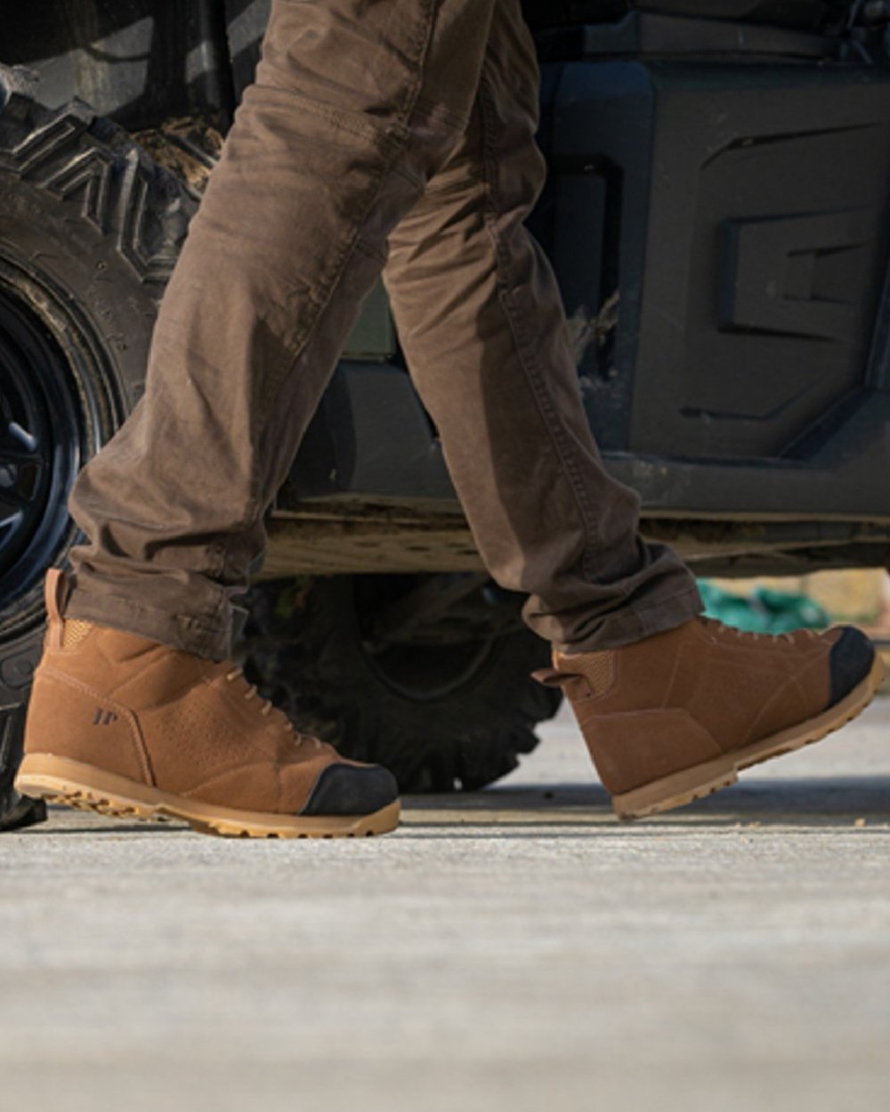 Brown coloured Jack Pyke Lowland Boots on car background 