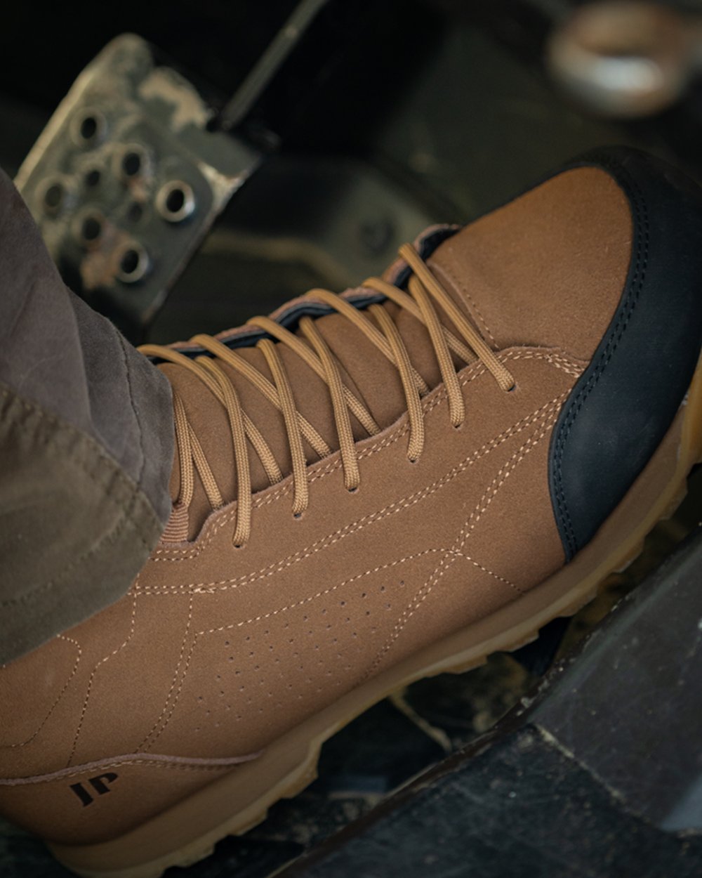 Brown coloured Jack Pyke Lowland Boots on car background 