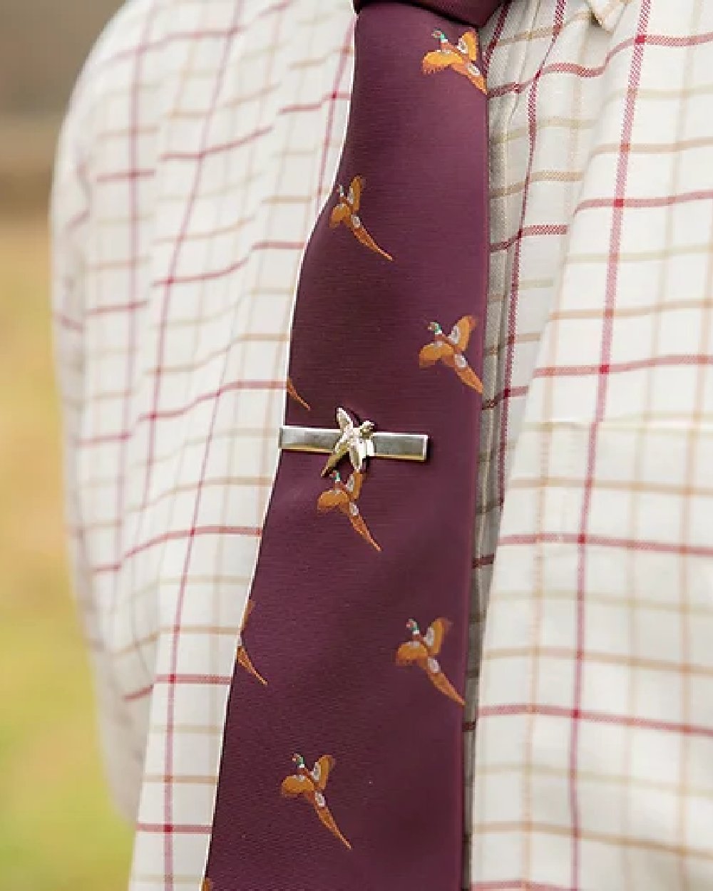 Pheasant styled Jack Pyke Pheasant Tie Clip on blurry background 