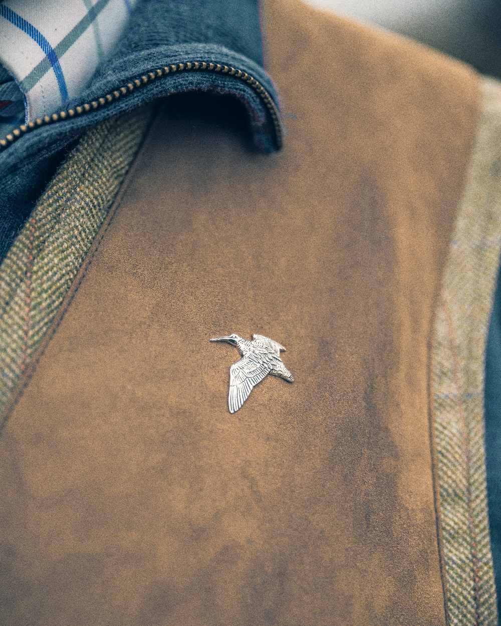 Woodcock styled Jack Pyke Pin Badge on blurry background 