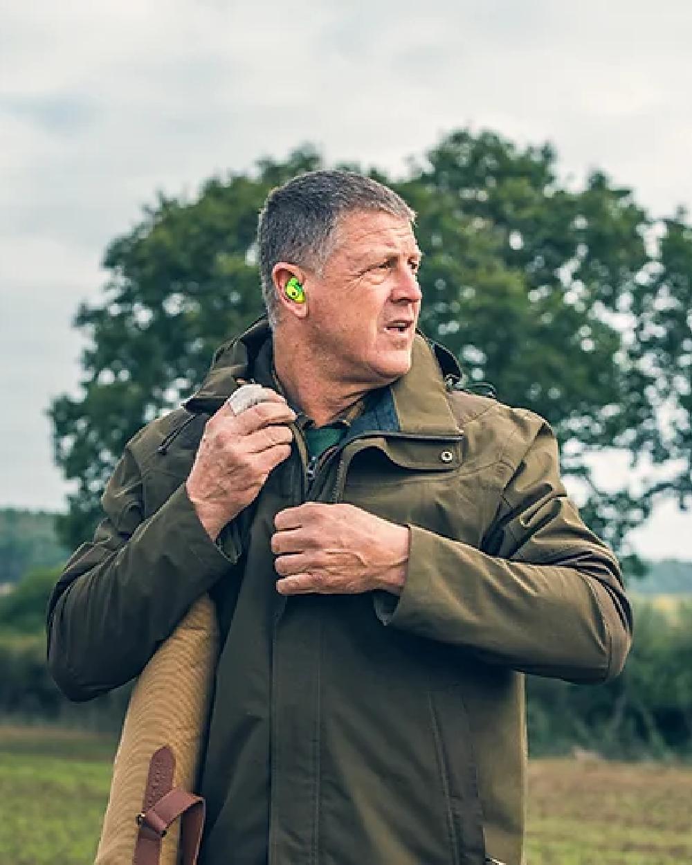 Green coloured Jack Pyke Pro-Lite Hunters Jacket on tree background 