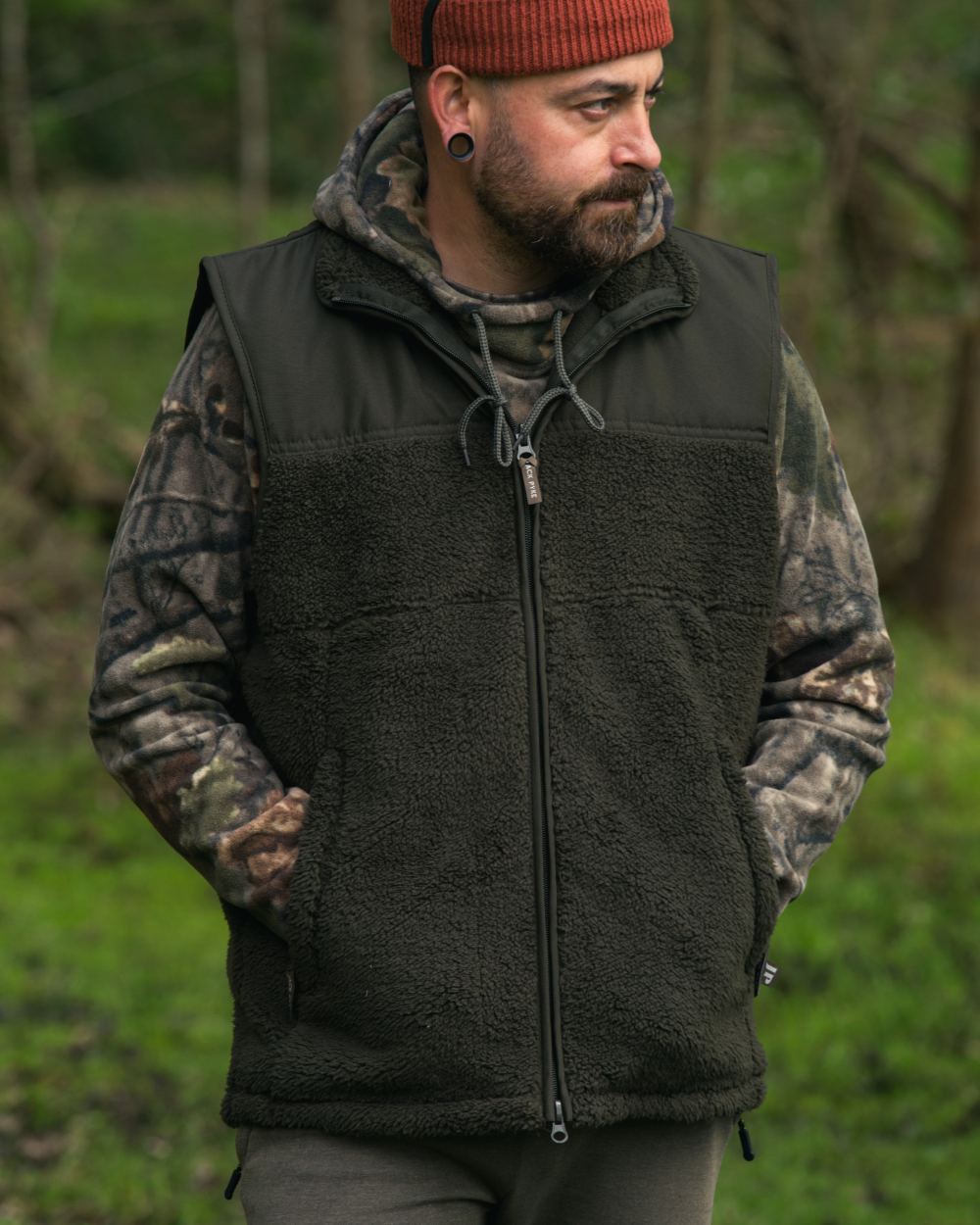 Dark Olive coloured Jack Pyke Sherpa Fleece Gilet on forest background 