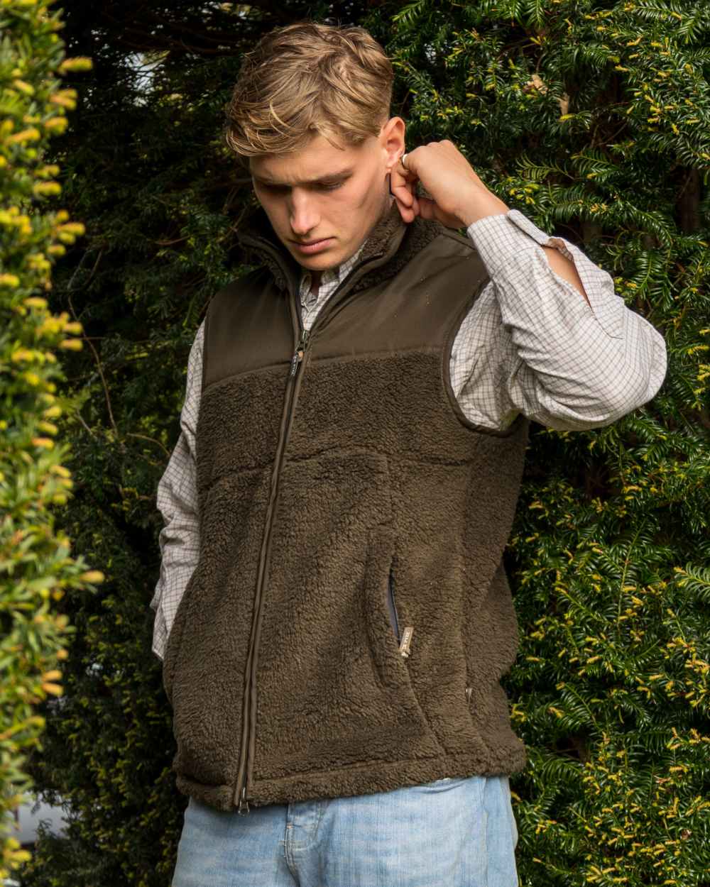 Dark Olive coloured Jack Pyke Sherpa Fleece Gilet on forest background 