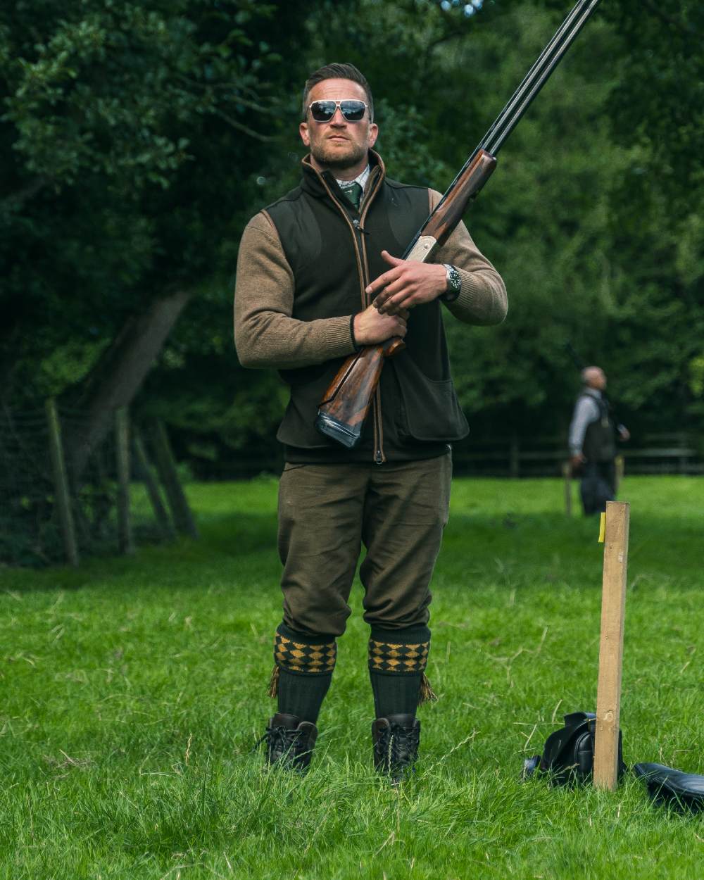 Dark Olive Jack Pyke Shooters Gilet on forest background 