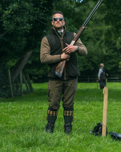 Dark Olive Jack Pyke Shooters Gilet on forest background 