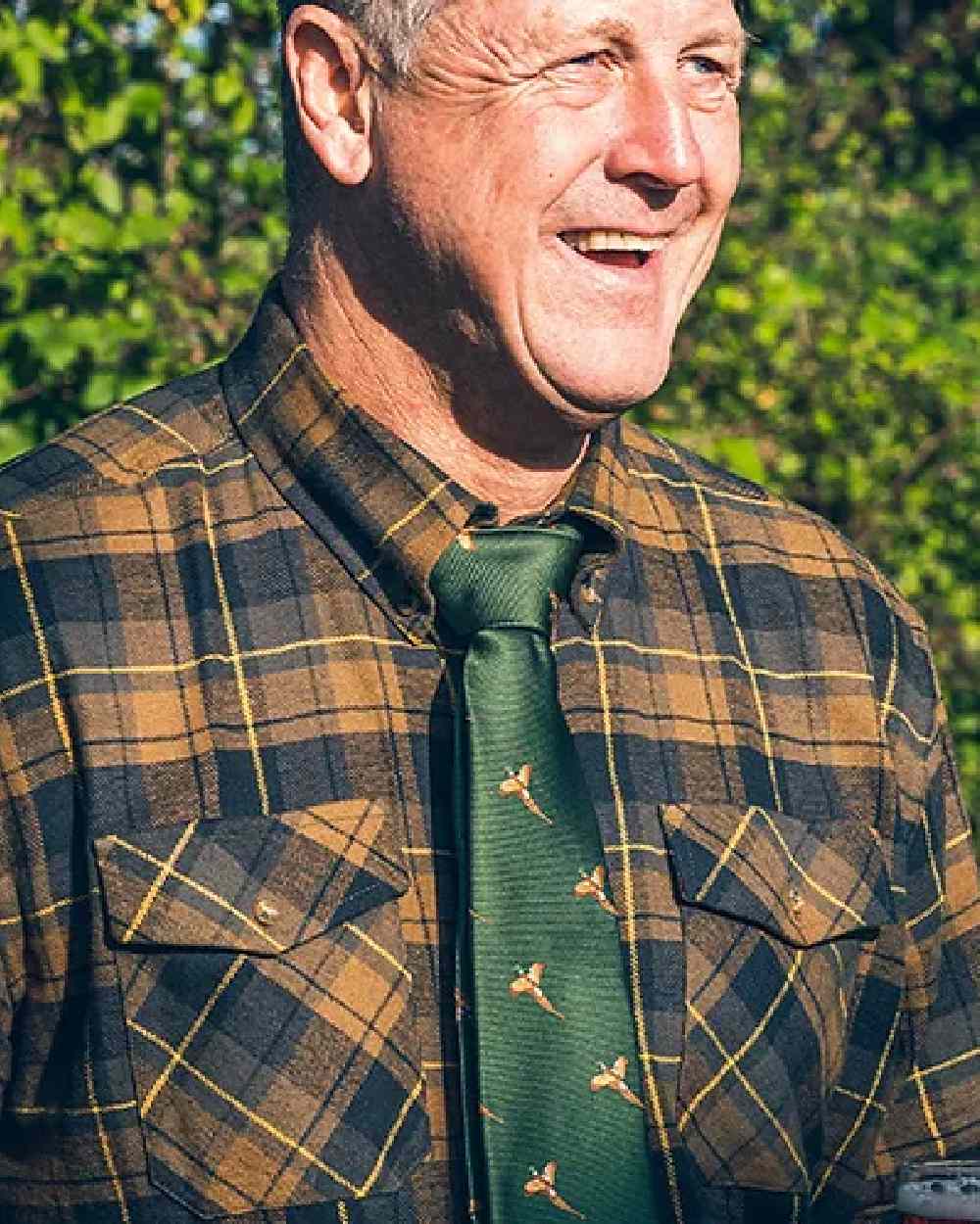 Green coloured Jack Pyke Shooting Tie Pheasant on blurry background 