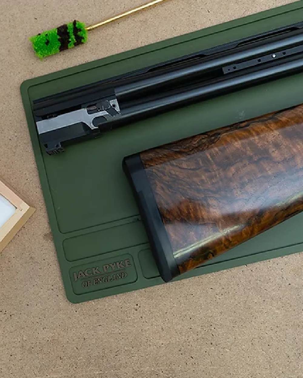 Green coloured Jack Pyke Silicone Gun Maintenance Mat on table background 