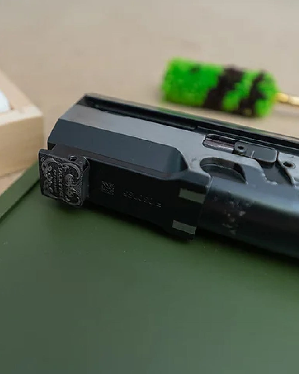 Green coloured Jack Pyke Silicone Gun Maintenance Mat on table background 