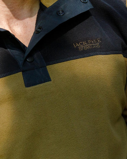 Dark Mustard coloured Jack Pyke Snap Neck Fleece Top on forest Background 