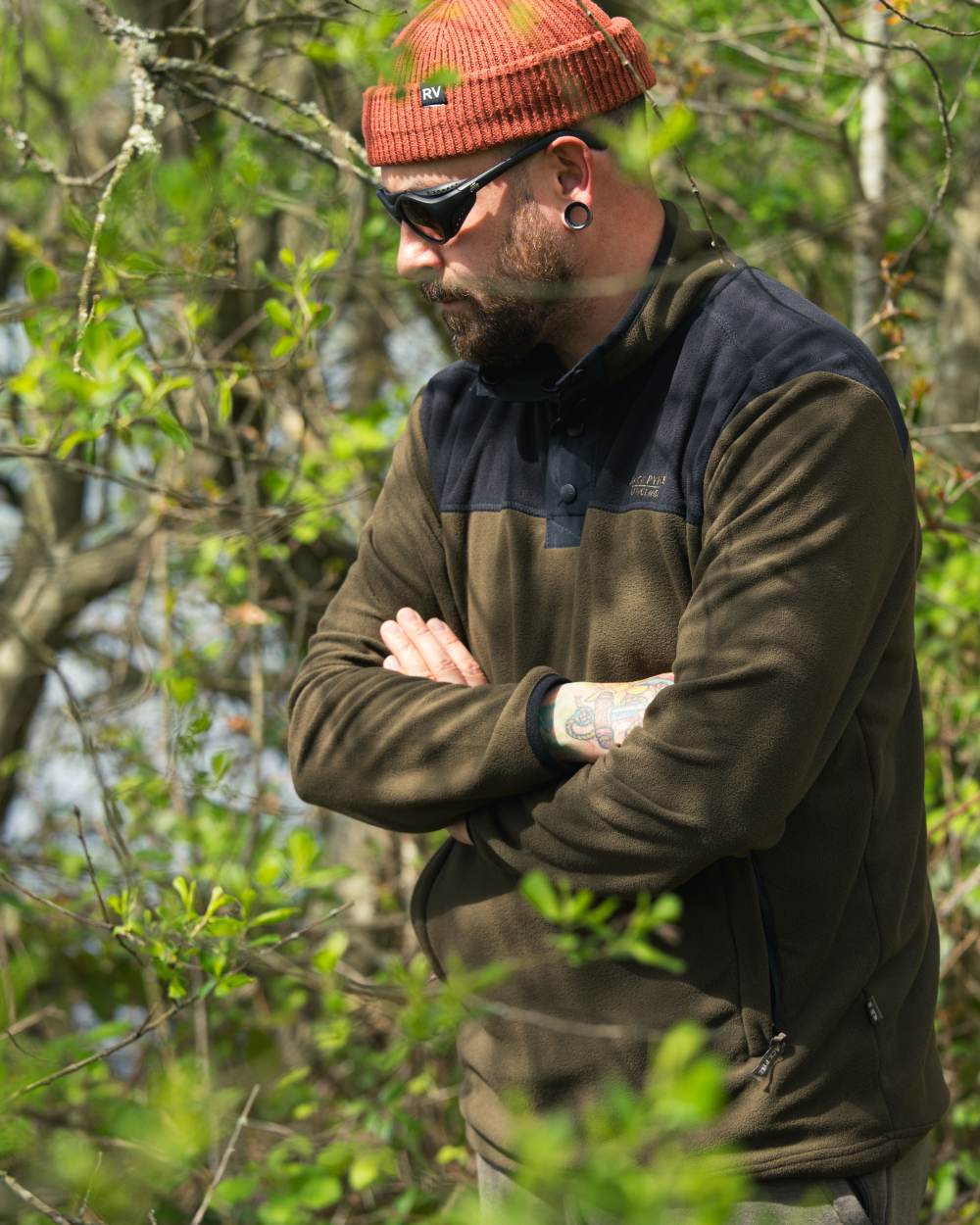 Dark Olive coloured Jack Pyke Snap Neck Fleece Top on forest Background 