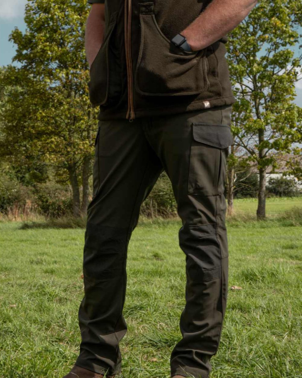 Green coloured Jack Pyke Softshell Trousers on grass background 