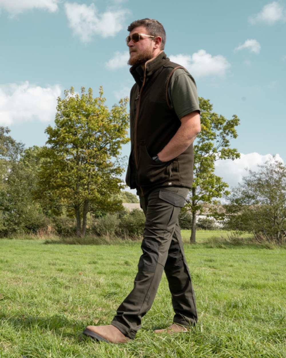 Green coloured Jack Pyke Softshell Trousers on grass background 