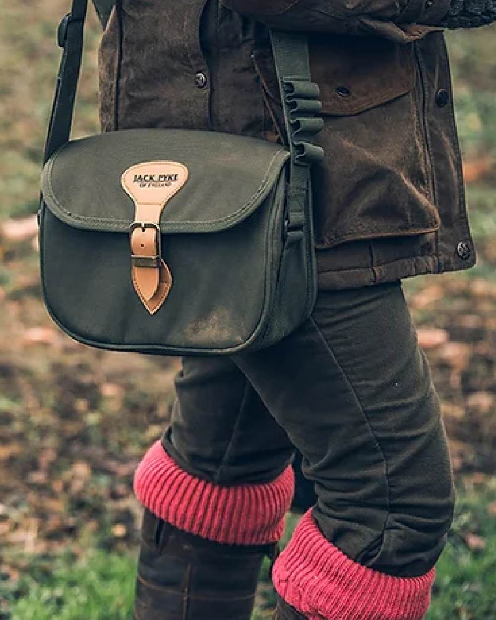 Green coloured Jack Pyke Speed Loader Cartridge Bag on blurry background 