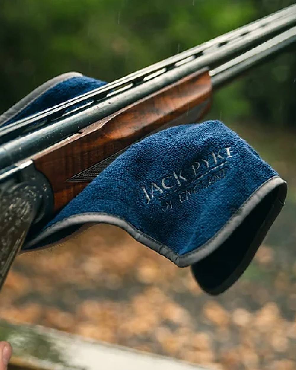 Blue coloured Jack Pyke Sporting Shooters Towel on blurry background 