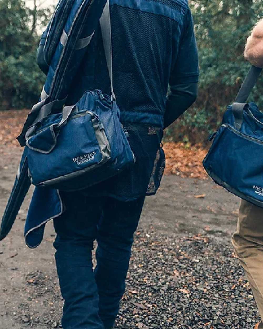 Blue coloured Jack Pyke Sporting Shoulder Bag on road background 