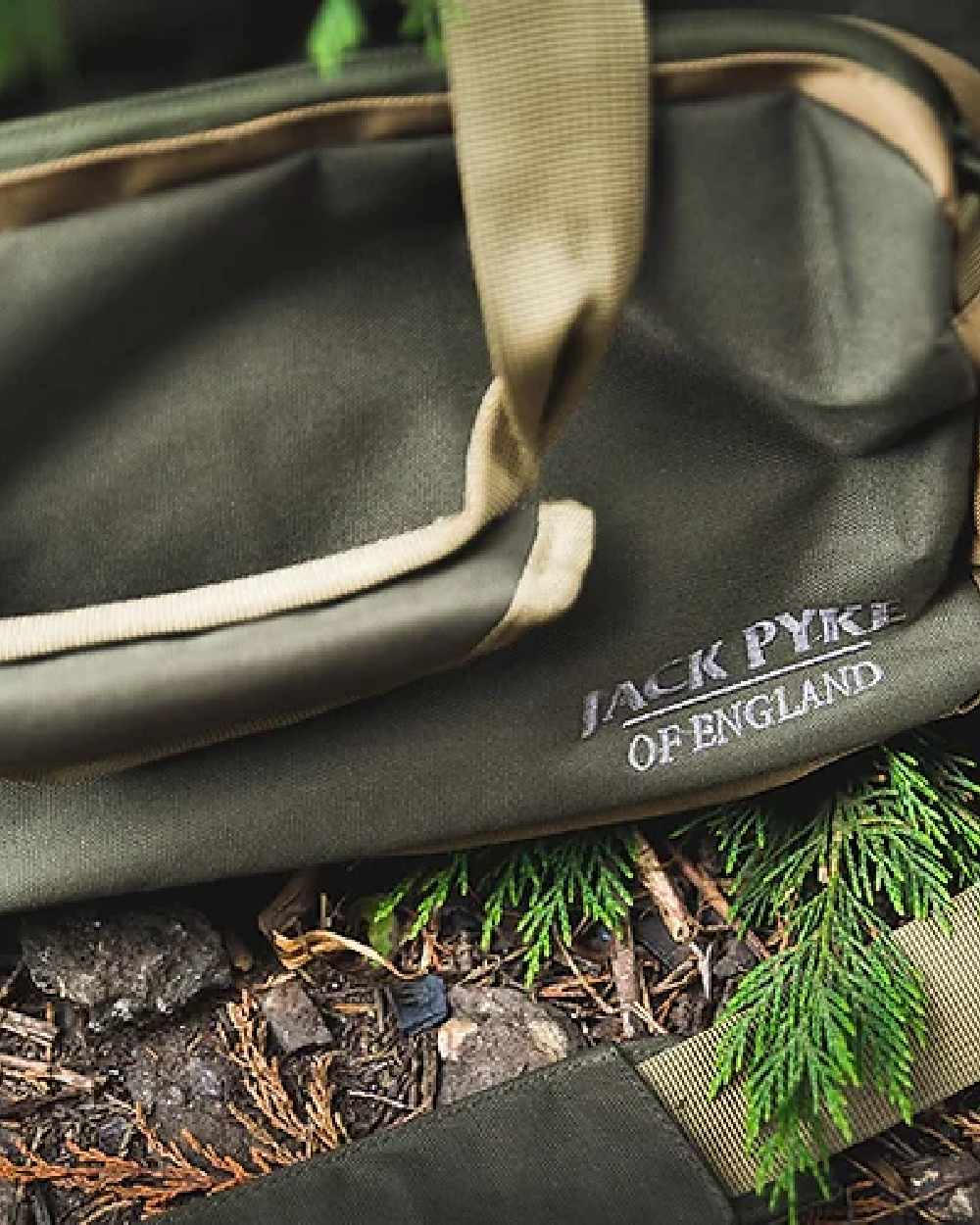 Green coloured Jack Pyke Sporting Shoulder Bag on mud background 