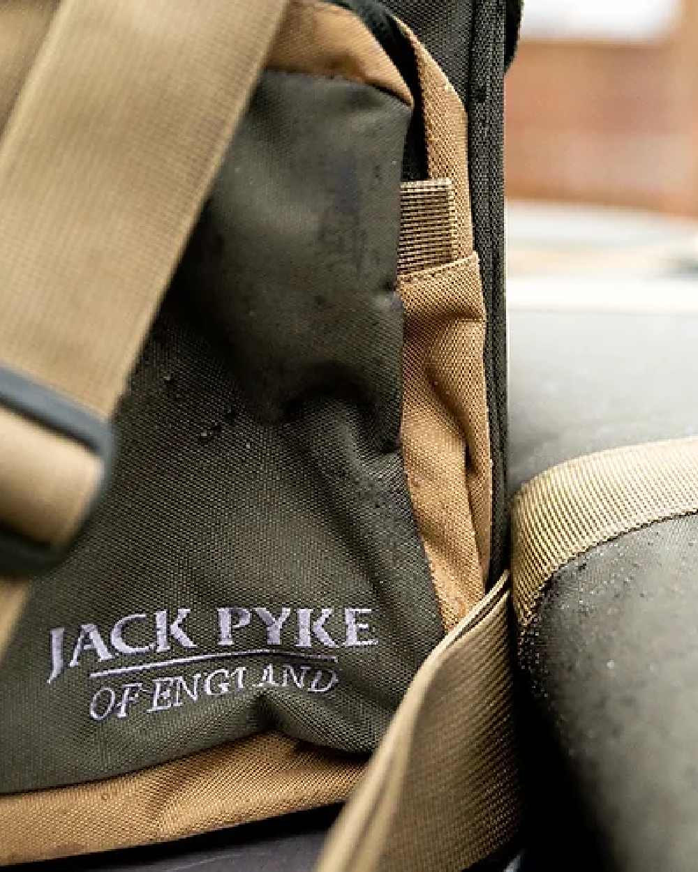Green coloured Jack Pyke Sporting Shoulder Bag on blurry background 