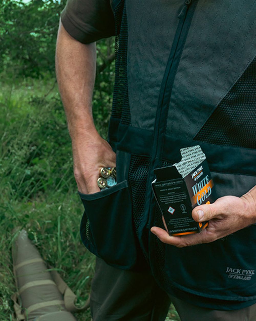 Black coloured Jack Pyke Sporting Skeet Vest on forest background 