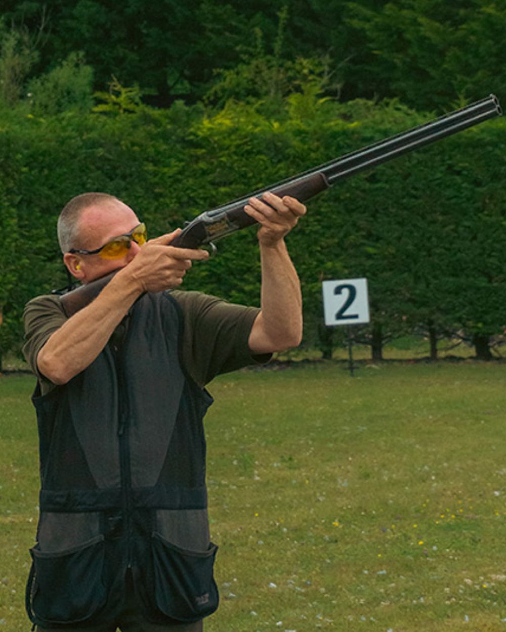 Black coloured Jack Pyke Sporting Skeet Vest on forest background 