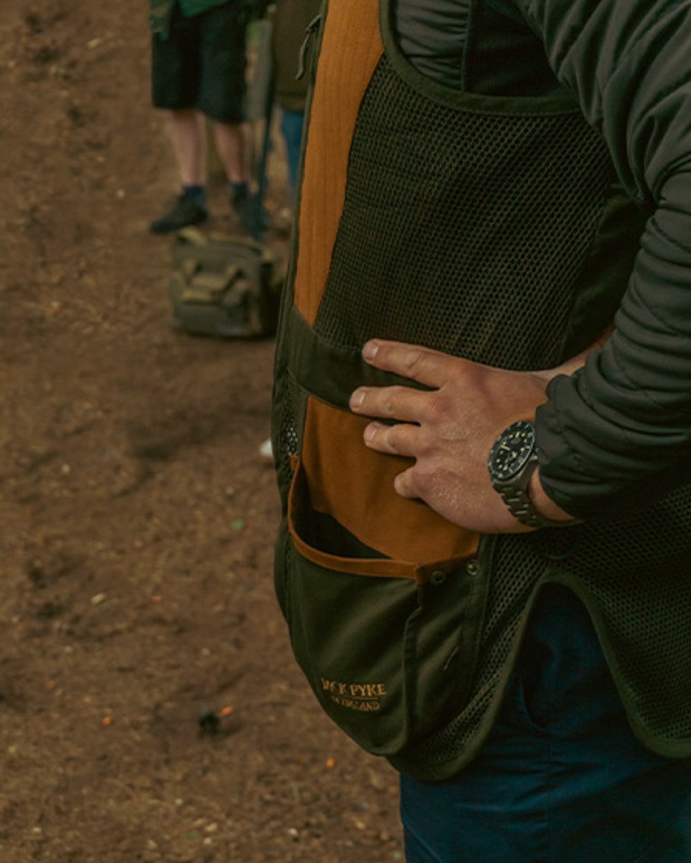 Green coloured Jack Pyke Sporting Skeet Vest on soil background 