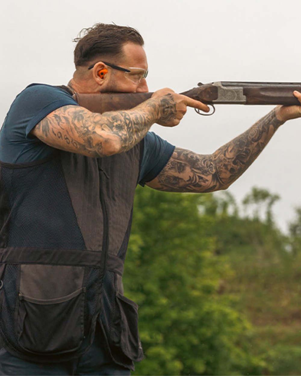 Navy coloured Jack Pyke Sporting Skeet Vest on blurry background 
