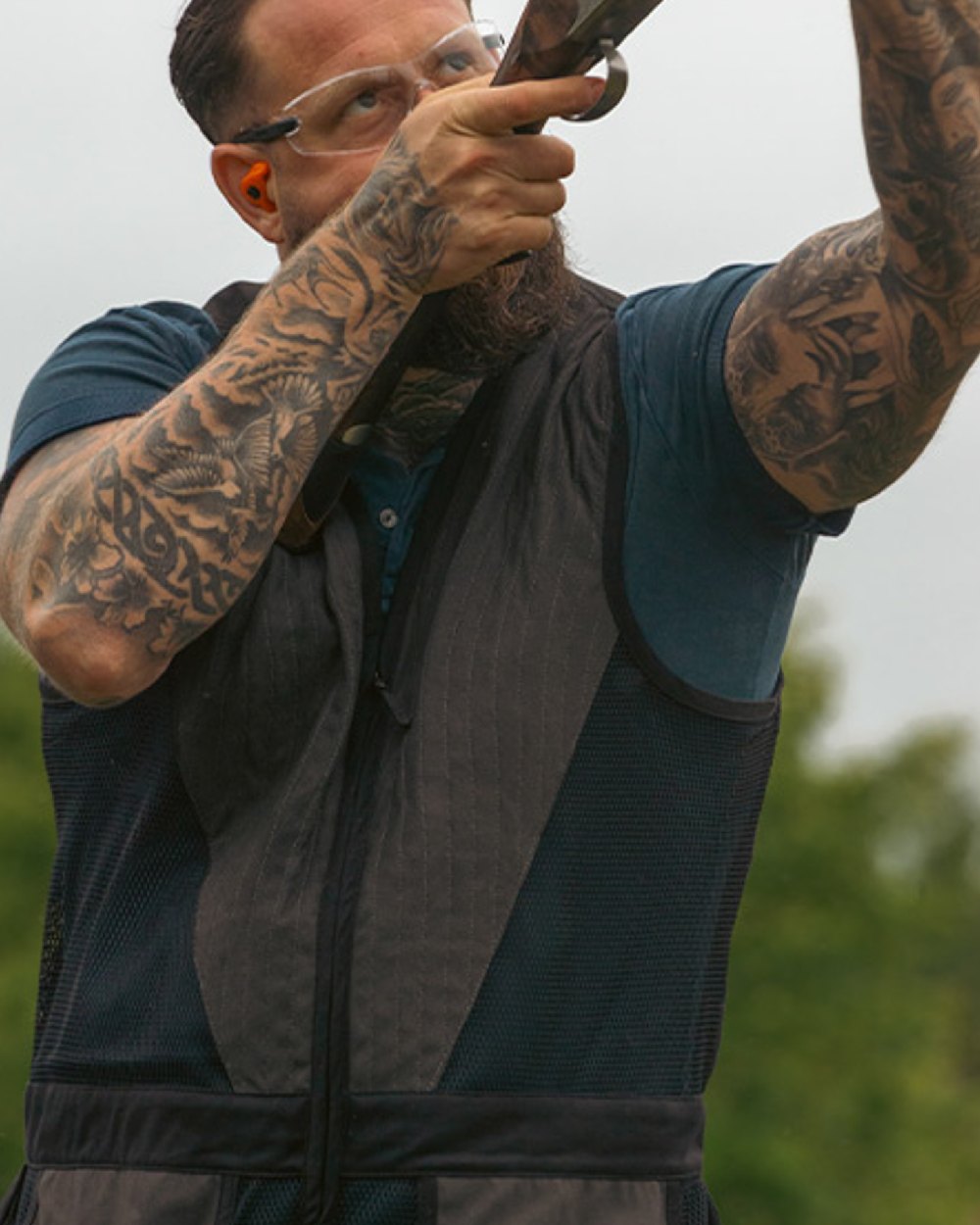Navy coloured Jack Pyke Sporting Skeet Vest on blurry background 
