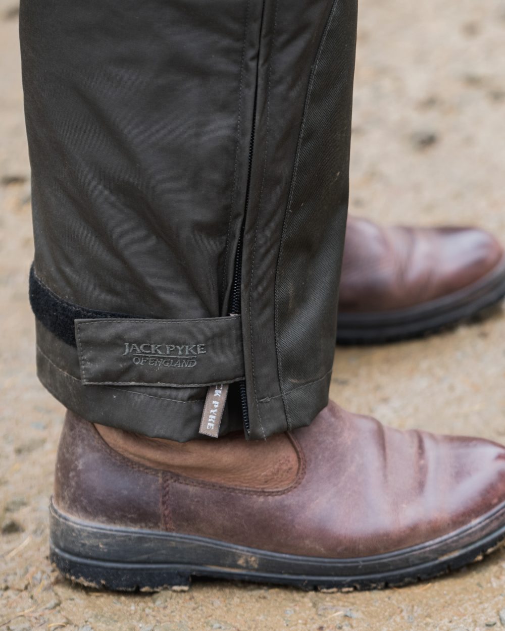 Hunters Green coloured Jack Pyke Technical Featherlite Trousers on soil background 