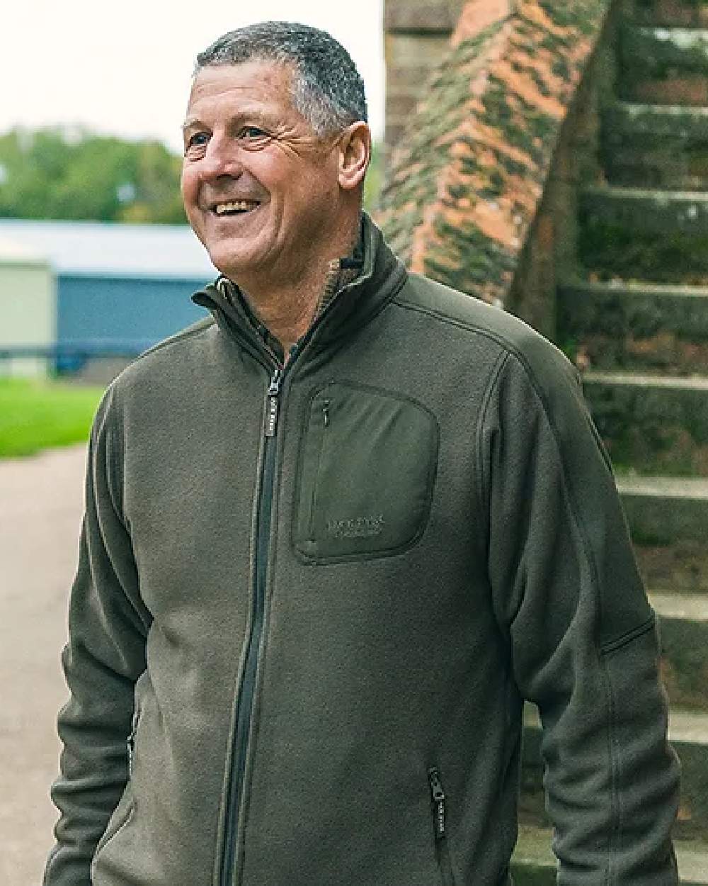 Green coloured Jack Pyke Weardale Fleece Jacket on blurry background 