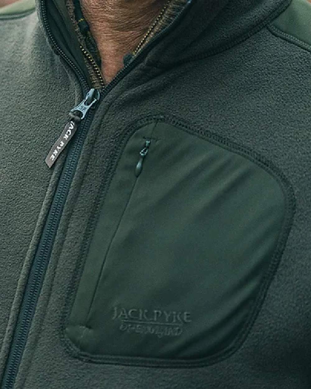 Green coloured Jack Pyke Weardale Fleece Jacket on blurry background 