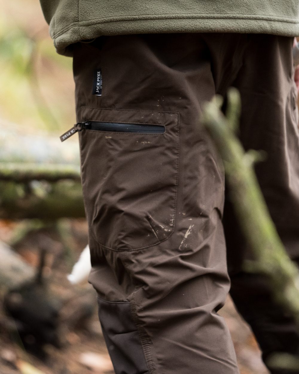 Brown coloured Jack Pyke Weardale Hunting Trousers on forest background 