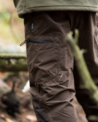 Brown coloured Jack Pyke Weardale Hunting Trousers on forest background 